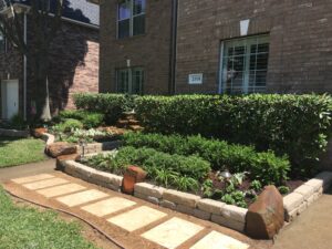 Neatly landscaped front bed with stone pathway.